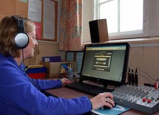 a volunteer editing audio files on the computer